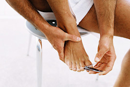 Image of a man trimming his toenails | American Academy of Dermatology (AAD)