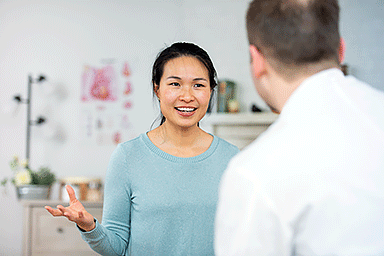 A woman of Asian descent talks to her doctor.