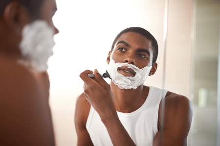 Man using sharp razor to prevent razor bumps