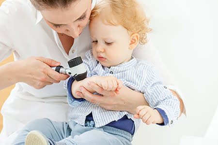 Baby boy at dermatologist for mole skin exam check-up