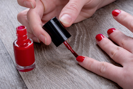 Woman painting nails with nail polish