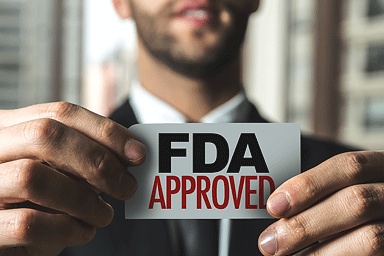 Man holding an FDA approved sign