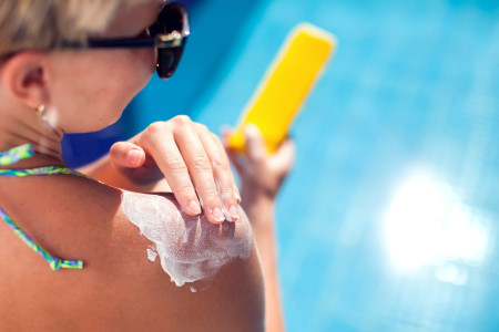 Person applying sunscreen