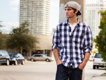 young man leaning on lamppost