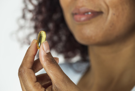 woman looking at pill