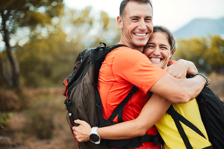 A couple hugging during their hike