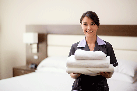 Hotel maid holding clean towels