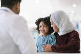 mother and child talking to doctors
