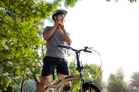 Smiling man riding a bicycle on a warm summer day