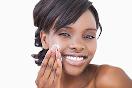 Image of a woman of color using a skin cream | American Academy of Dermatology (AAD)