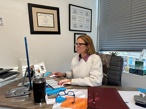 Emmy Graber, MD, MBA, FAAD, checking portal messages between patients at her practice in Boston. Photo courtesy of Dr. Graber. | American Academy of Dermatology (AAD)