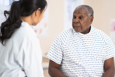 Dermatologist caring for patient.