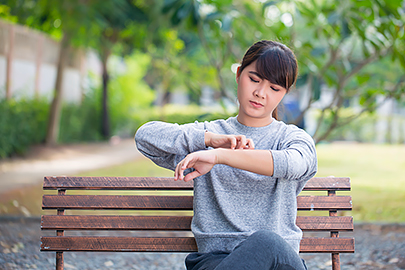 woman scratching arm