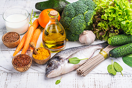 Fresh vegetables, a fish, and other healthy foods