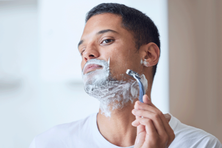 Man shaving beard in a way that helps prevent razor bumps