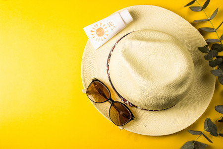 Image of summer hat, sunglasses and sunscreen