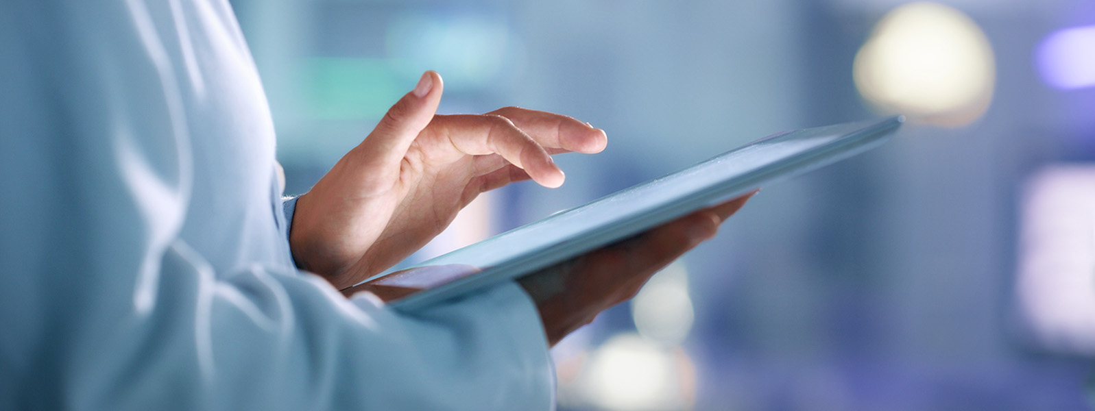 Clinician holding tablet to illustrate health IT solutions content