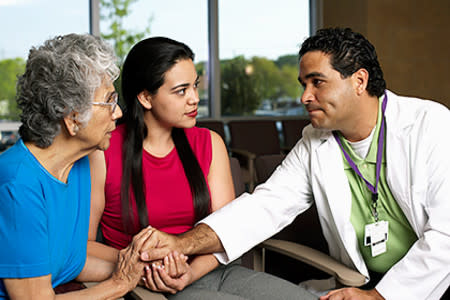 A dermatologist meets with his patient and her daughter