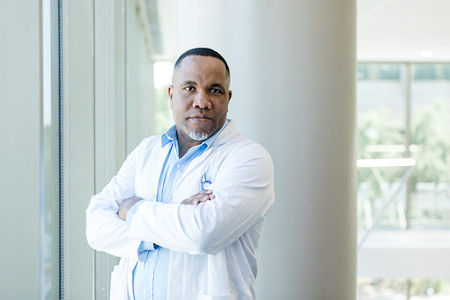 Dermatologist in white coat ready to take action against Medicare cuts.