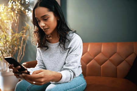 Woman using a symptom checker app on her phone 