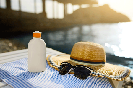 Blanket with wide-brimmed hat, sunglasses, and sunscreen, which can reduce your risk of developing squamous cell skin cancer