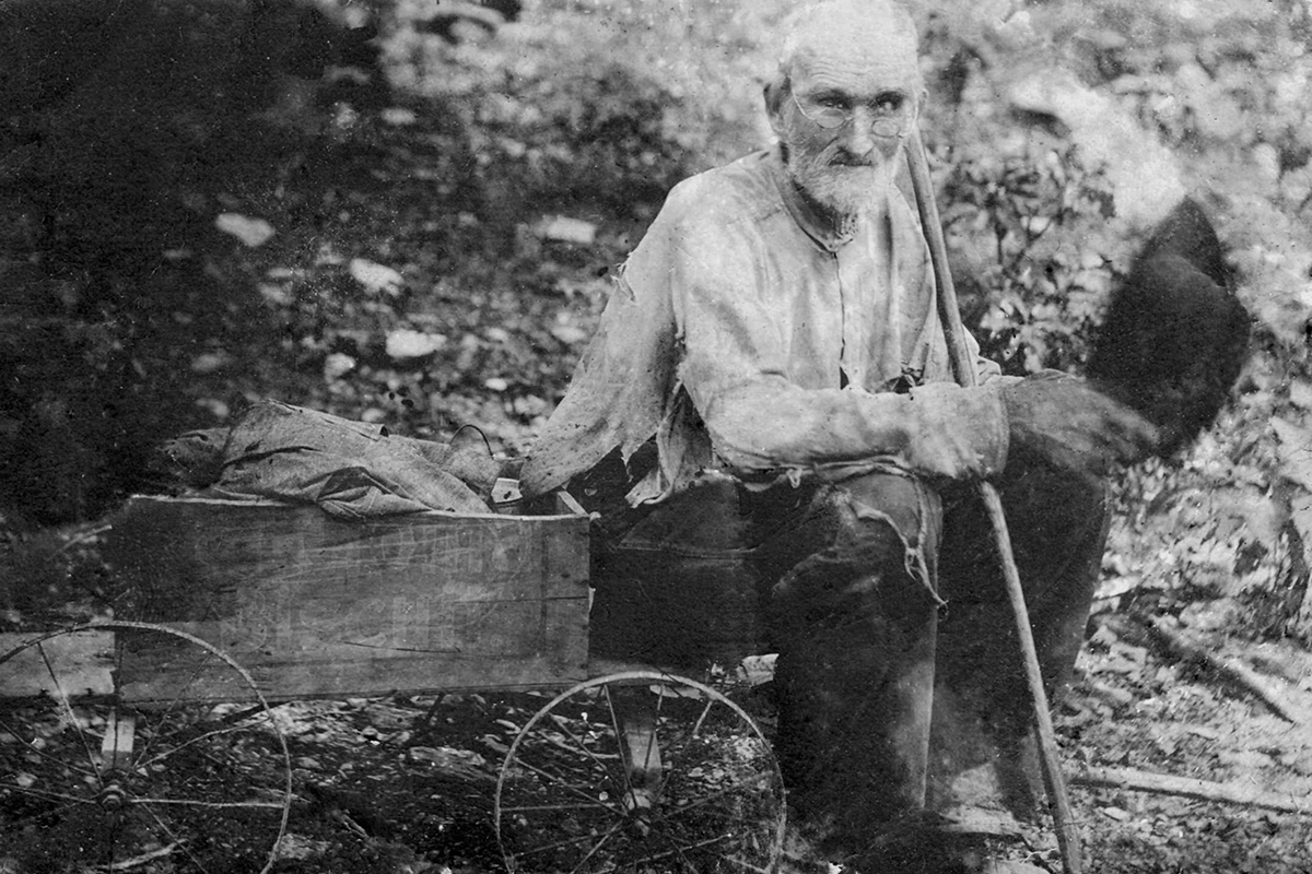 Restored photo of Sanford Gray Ramsey sitting on a small wagon