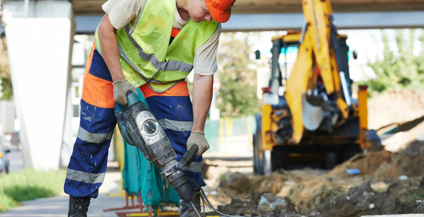 construction worker drilling at a construction site