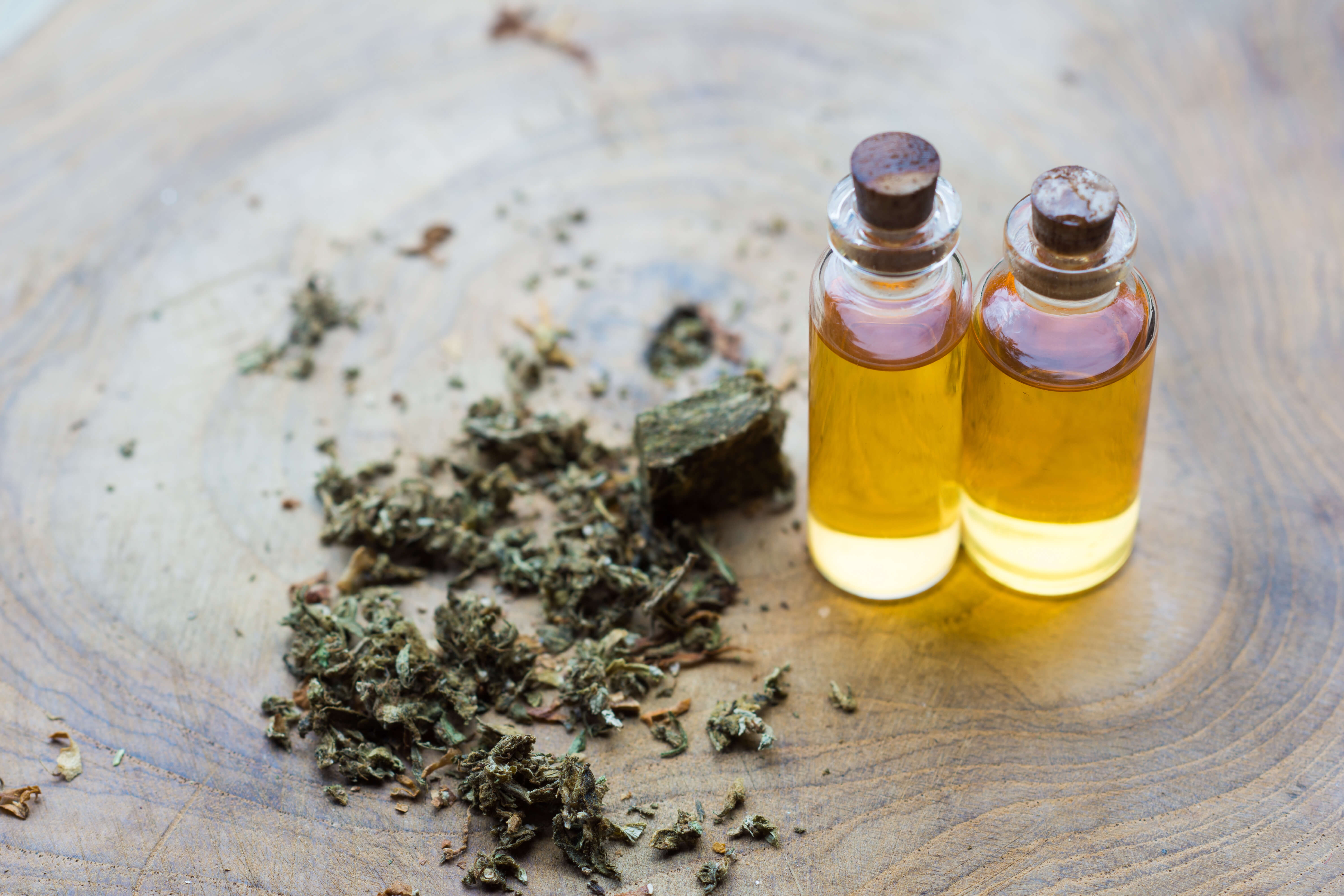 Terpenes: A Comprehensive Guide 4 Terpenes beside two bottles of CBD oil.
