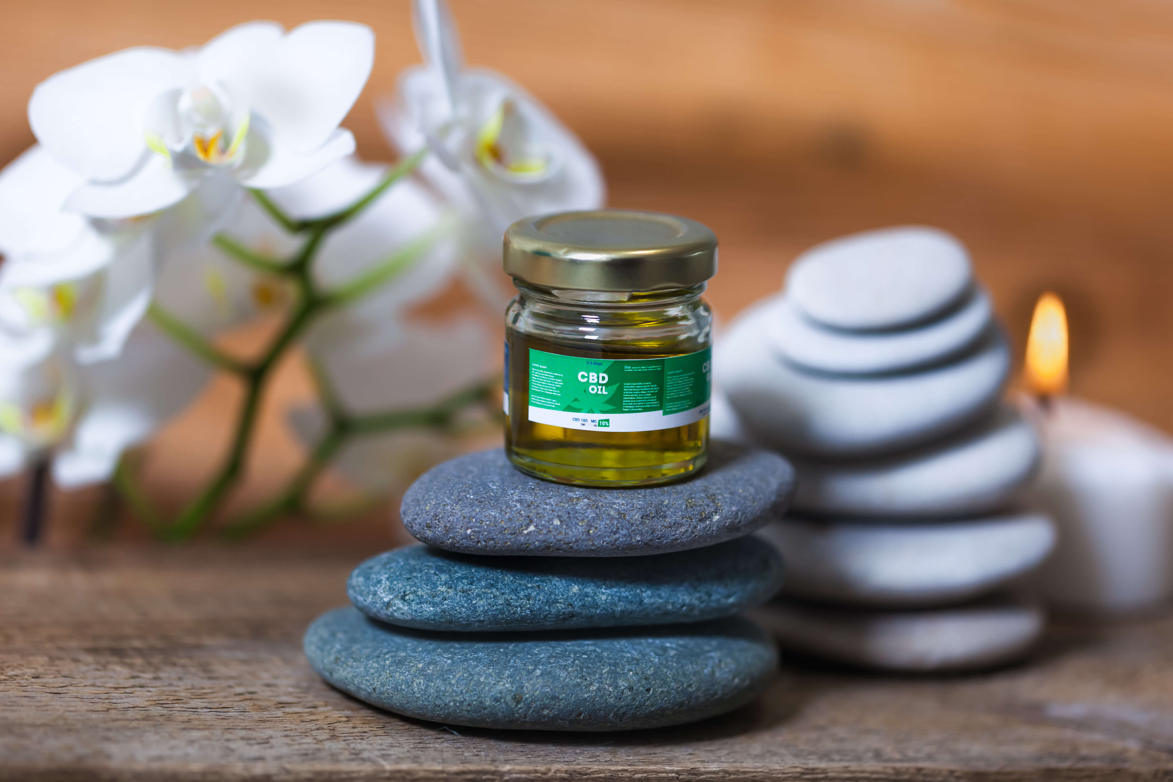 CBD Isolate: A Complete Guide 3 A jar of CBD oil for dogs sitting on top of a stack of smooth rocks.