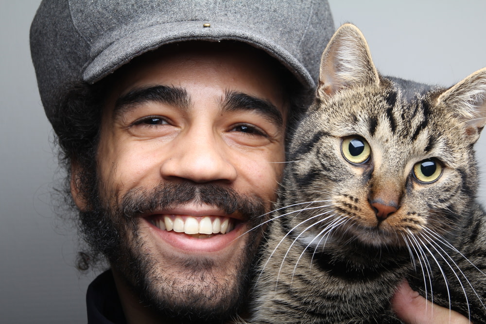 Why Your Cat May Be Crying And What To Do About It 5 smiling pet owner with his happy cat