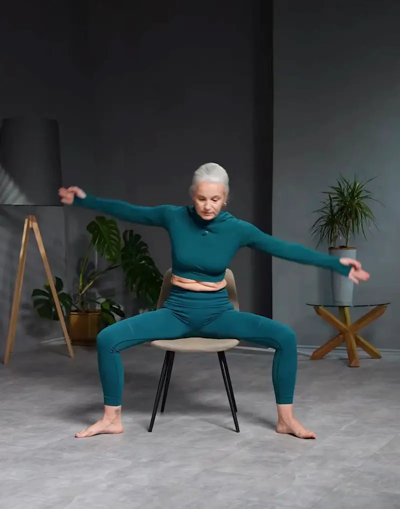 https://welltechdev.wpengine.com/wp-content/uploads/2023/08/side_stretch_legs_apart_chair-yoga-for-seniors.webp