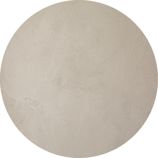 Une surface ronde et beige, texturée, qui ressemble à un carreau de pierre ou de béton sur fond blanc.