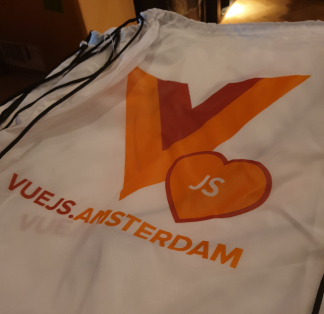 Photo of a bag which has the VueJS Amsterdam logo printed on it