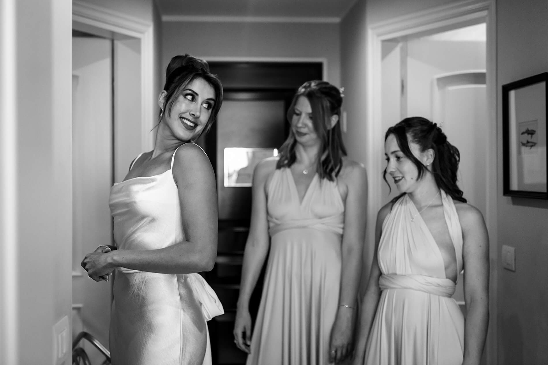 la sposa si guarda allo specchio il vestito guardata dalle damigelle, all'hotel royal di Sanremo.