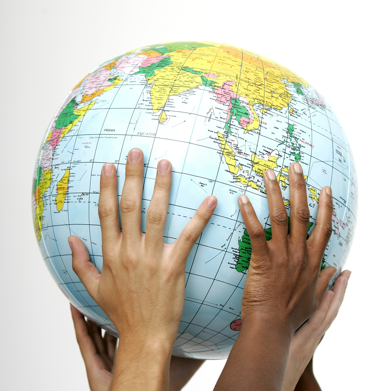 Five different children's hands raising up a globe