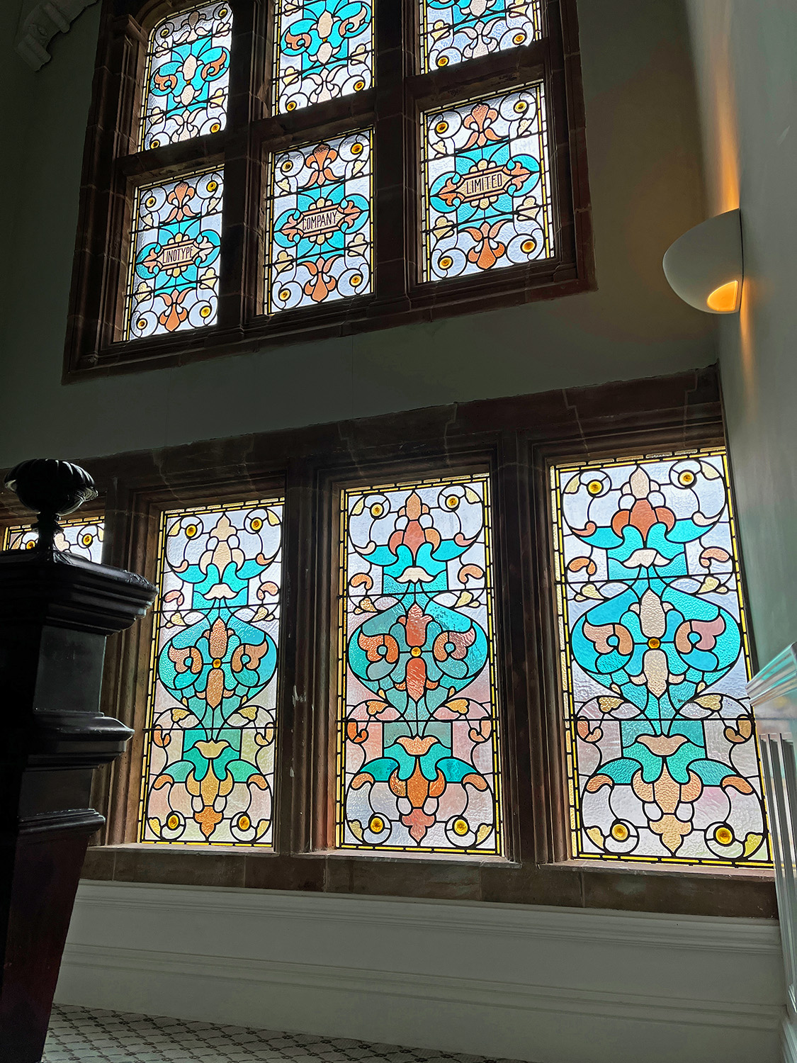 Looking up from the staircase at the stained glass.