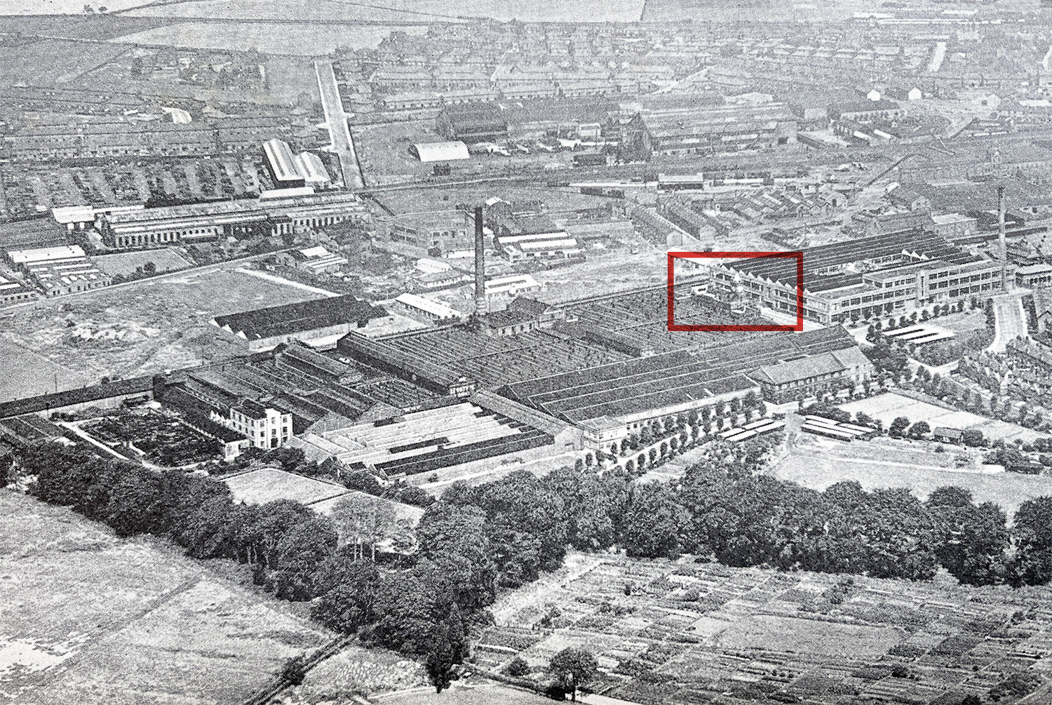 An aerial photo from 20 years later (1951) showing the growth of the factory and other buildings. The red box highlights the admin building from the rear.