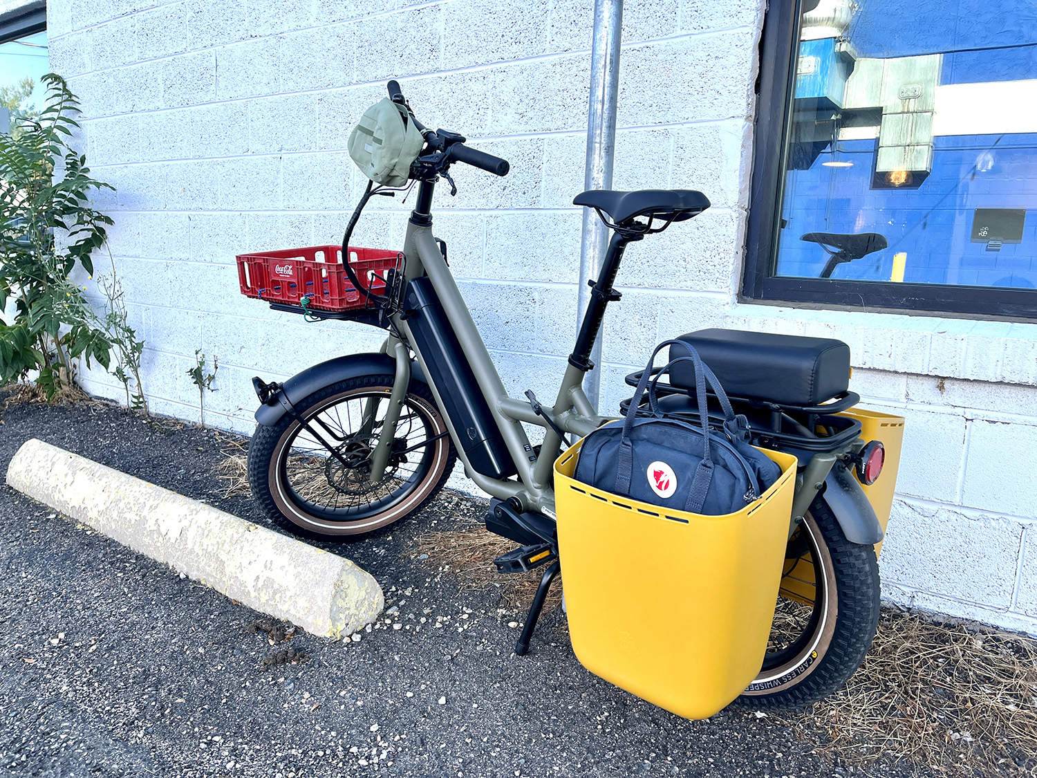 Globe Haul ST bike with yellow panniers and a red rack on the front
