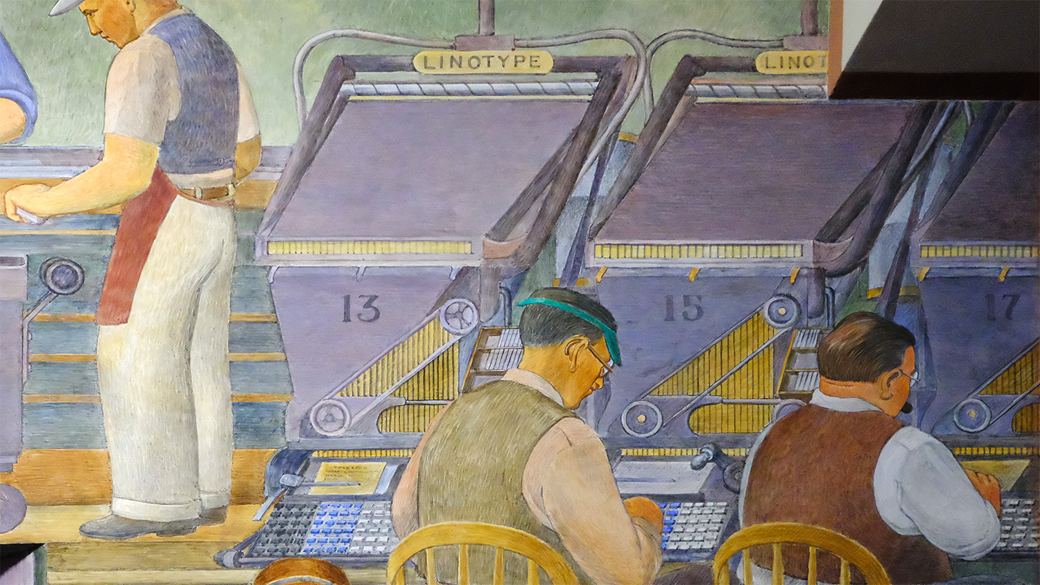 Close-up of the three Linotypes in action — the artist even got the colors of the Linotype keyboards correct!