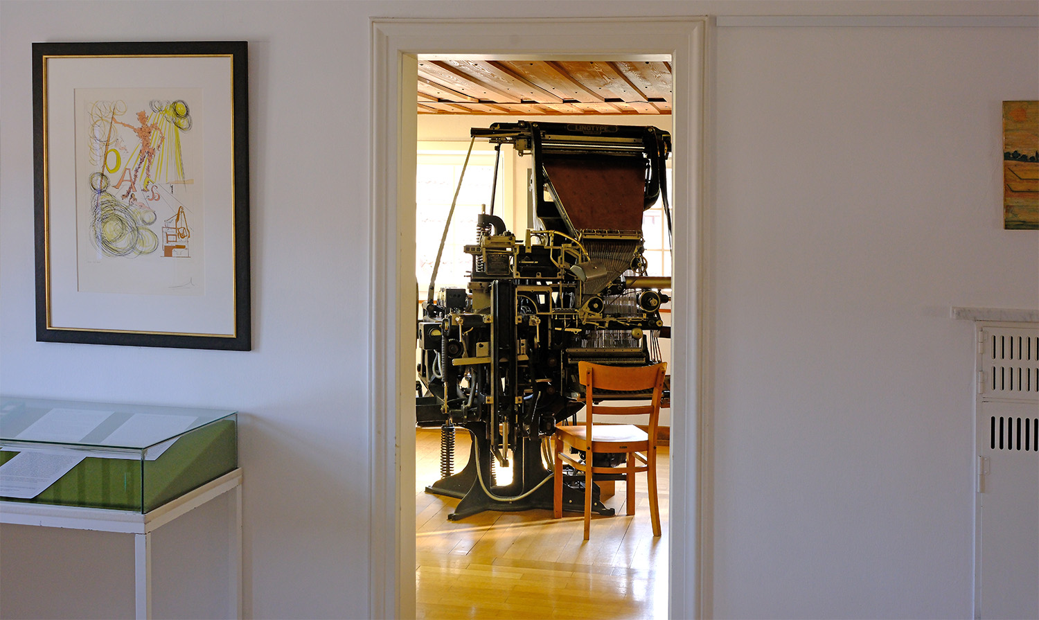 Looking at the 1904 Linotype on display with the Salvador Dalí print to the left. This room is where the box was uncovered.