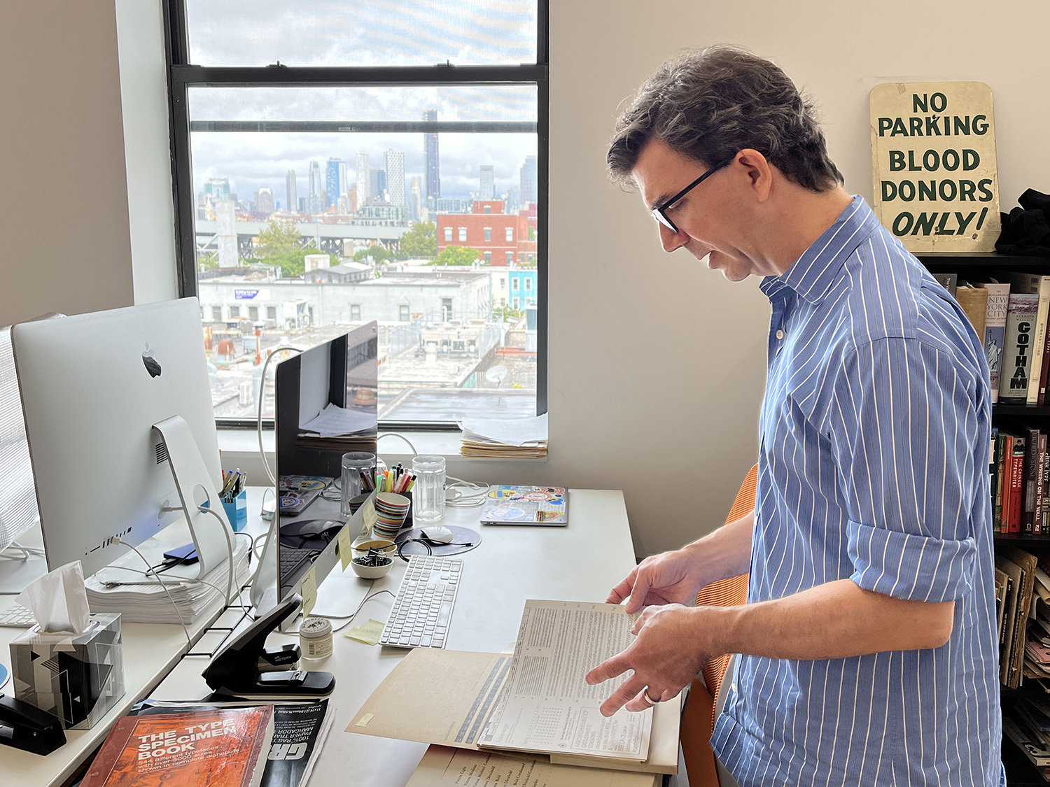 Tobias at Nina Stössinger’s desk, with downtown Brooklyn in the background