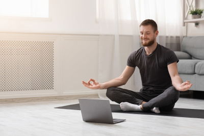 A man with a de-stressed expression practising yoga. A man with a de-stressed expression practising yoga.