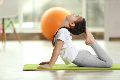 A kid practising Rajkapotasana. A kid practising Rajkapotasana.