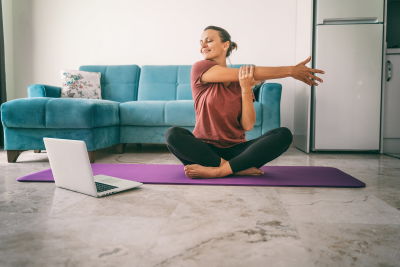 A woman doing a shoulder stretch. A woman doing a shoulder stretch.