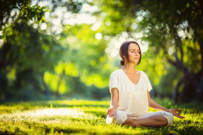 A woman meditating mindfully.