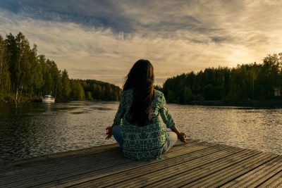 Woman meditating in a scenic location.