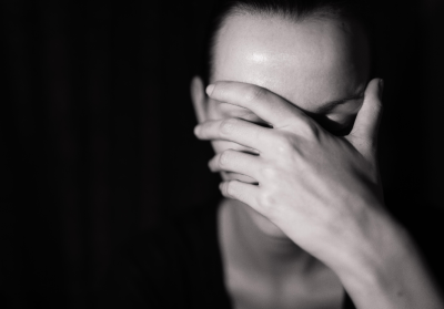 Woman covering her face Woman covering her face
