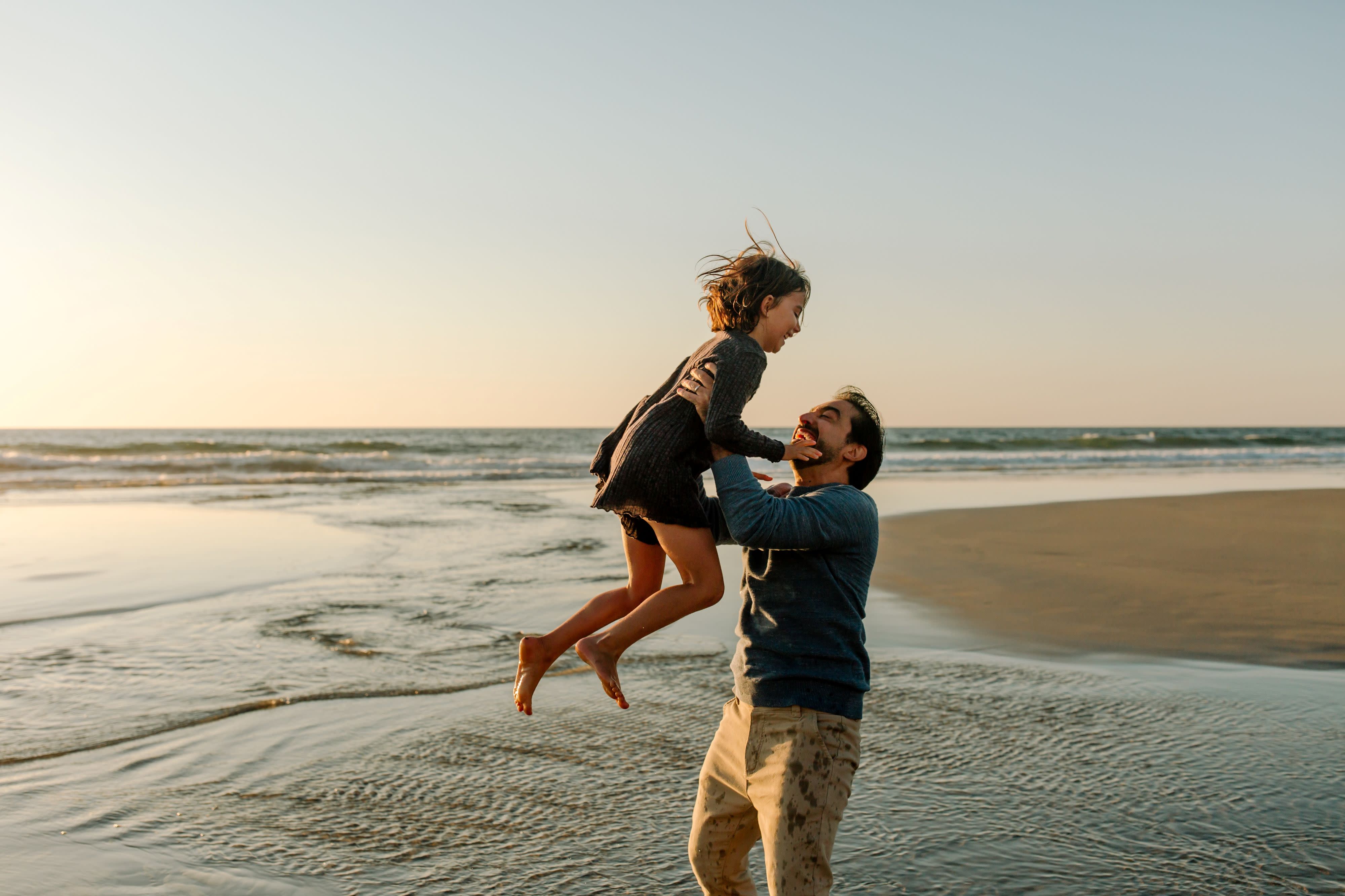 man and child on the beach