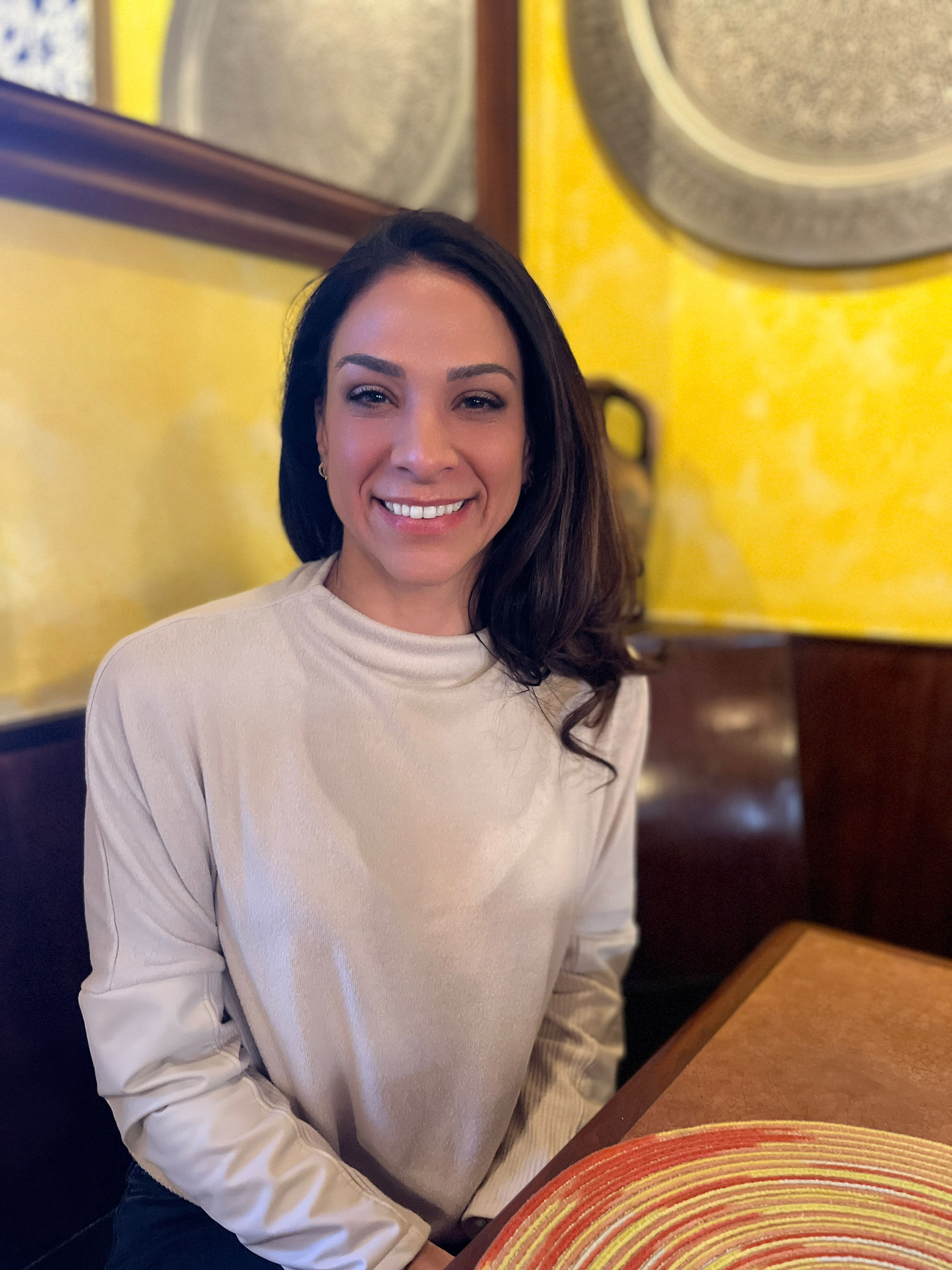Woman wearing white in room with yellow walls.