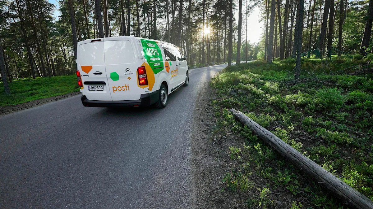 Posti's delivery van driving on a road that runs through a forest.
